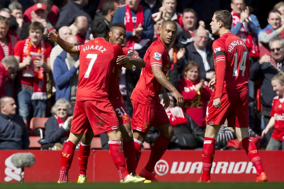 Liverpool's Raheem Sterling, second left, celebrates with teammates after scoring against Manchester City durig their English Premier League soccer match at Anfield Stadium, Liverpool, England, Sunday April 13, 2014. (AP Photo/Jon Super)