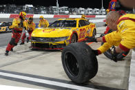 Crew members perform a pit stop on the car of Joey Logano during the NASCAR All-Star auto race at North Wilkesboro Speedway in North Wilkesboro, N.C., Sunday, May 19, 2024. (AP Photo/Chuck Burton)