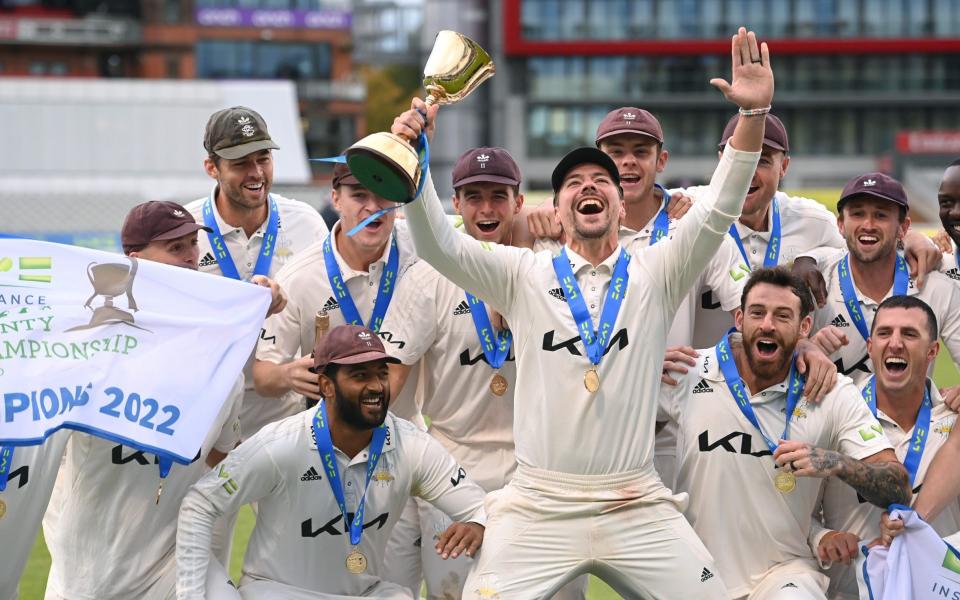 Surrey captain Rory Burns (with trophy) leads the celebrations after Surrey's County Championship success - Getty Images