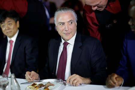 Brazil's President Michel Temer eats barbecue in a steak house after a meeting with ambassadors of meat importing countries of Brazil, in Brasilia, Brazil March 19, 2017. REUTERS/Ueslei Marcelino
