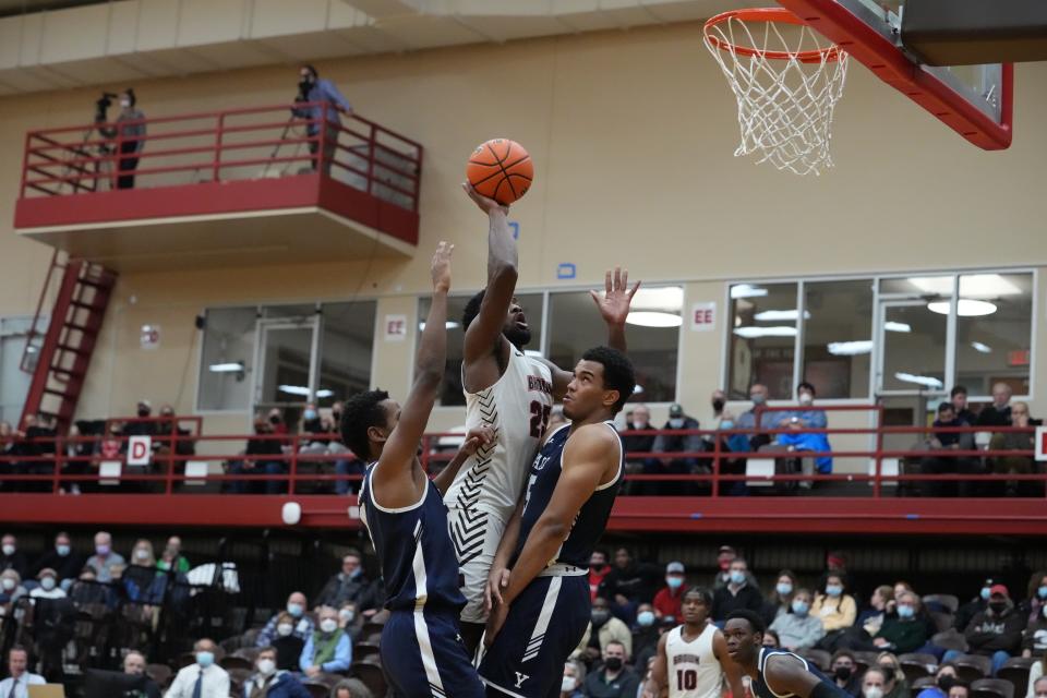 Brown's Tamenang Choh goes up for a shot against two Yale defenders on Monday night.