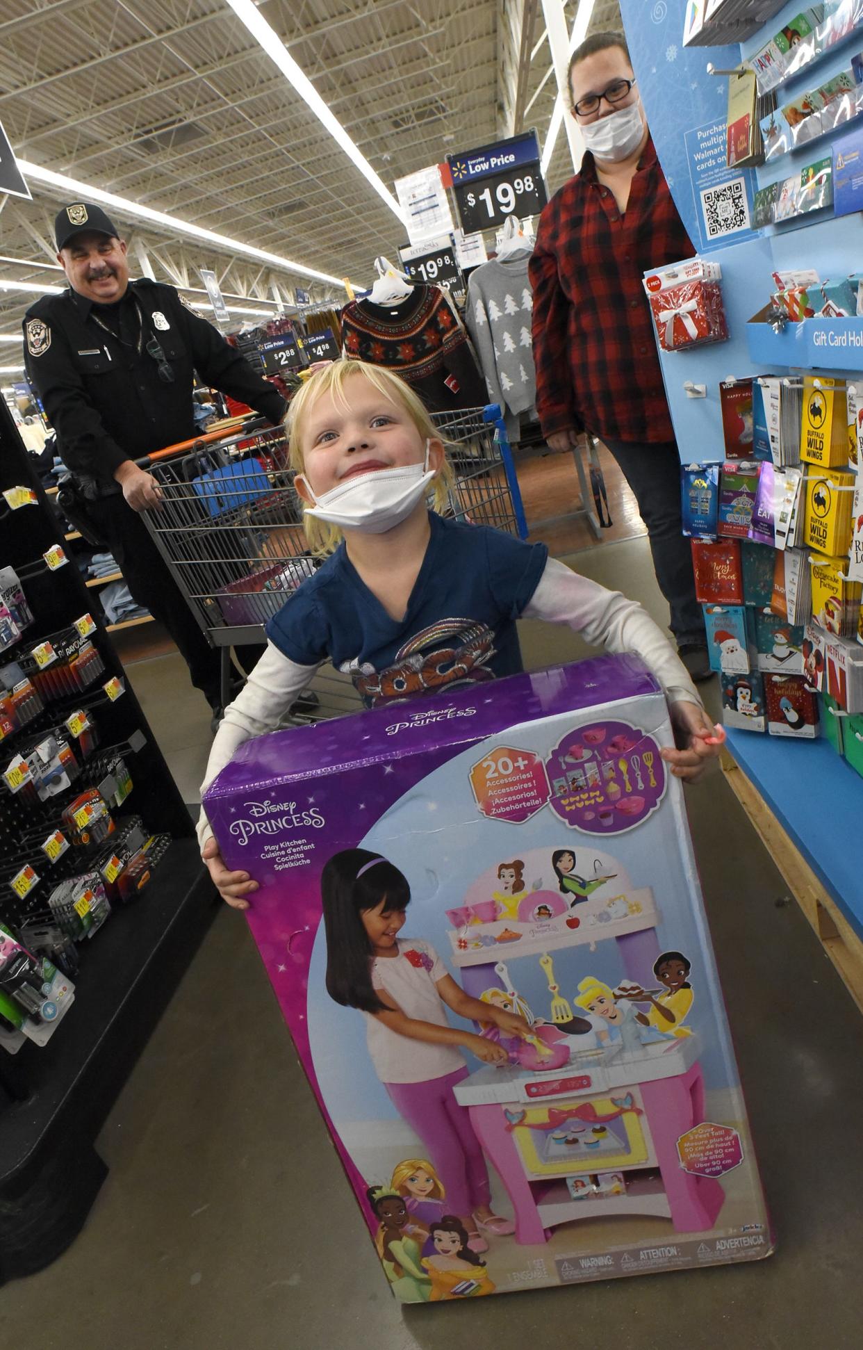 Dundee Elementary kindergartner Darlyne Billau, 5, was excited about her princess kitchen that she picked out with Dundee Police Officer Chris McGlynn, along with her mother, Barbara Gardner. Darlyne was one of several children who participated in the annual 'Shop With A Cop' at Walmart on Thursday.