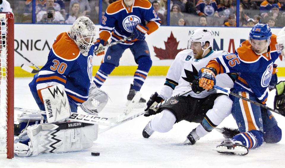 San Jose Sharks Joe Pavelski (8) is stopped by Edmonton Oilers goalie Ben Scrivens (30) as Martin Marincin (85) tries to defend during the first period of an NHL hockey game in Edmonton, Alberta, on Wednesday, Jan. 29, 2014. (AP Photo/The Canadian Press, Jason Franson)