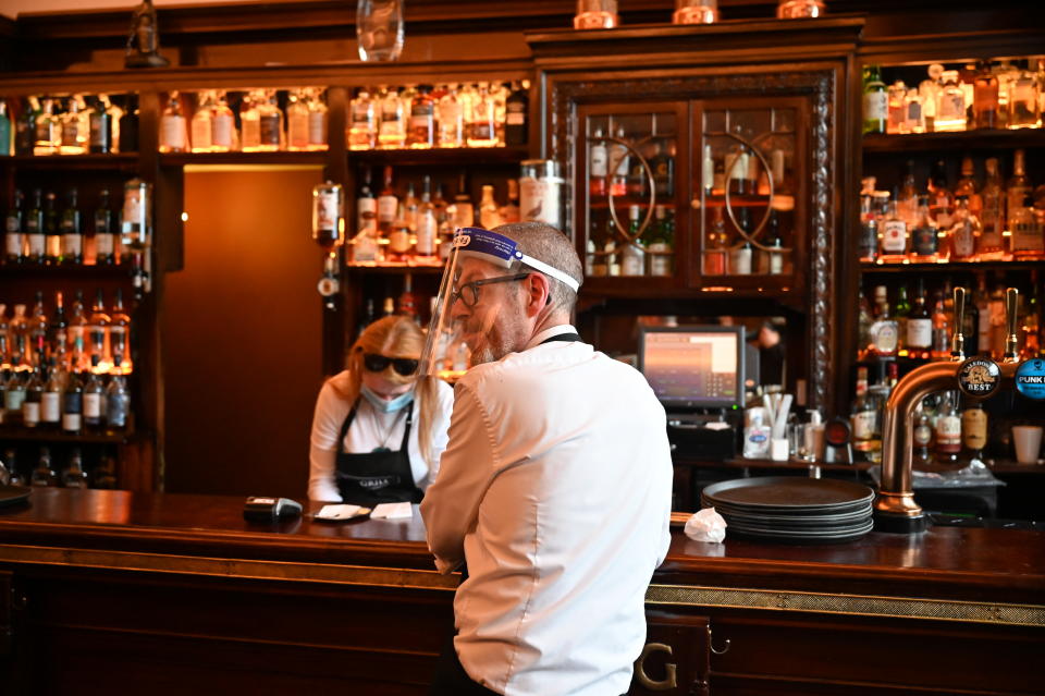 ABERDEEN, SCOTLAND - AUGUST 05: Kieth McKenzie wears a shielding face mask as he works in the pub The Grill in Union Street on August 5, 2020 in Aberdeen, Scotland. Scotland's First Minister Nicola Sturgeon acted swiftly and put Aberdeen back into lockdown after cases of Coronavirus in the city doubled in a day to 54. She ordered all indoor and outdoor hospitality venues to close by 5pm. (Photo by Jeff J Mitchell/Getty Images)