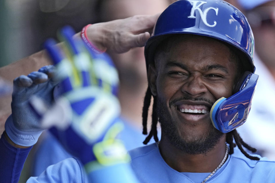 Kansas City Royals shortstop Maikel Garcia celebrates in the dugout after scoring on a sacrifice fly hit by Salvador Perez during the third inning of a baseball game against the Chicago White Sox Monday, Sept. 4, 2023, in Kansas City, Mo. (AP Photo/Charlie Riedel)