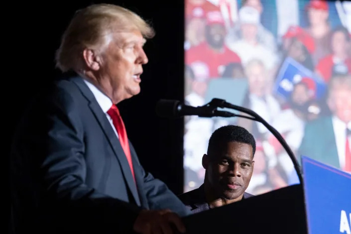 Former President Donald Trump speaks as Georgia Senate candidate Herschel Walker listens during his Save America rally in Perry, Ga., on Saturday, Sept. 25, 2021.