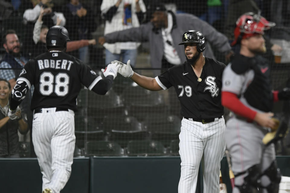 Chicago White Sox's Luis Robert (88) celebrates with teammate Jose Abreu (79) after hitting a solo home run during the first inning of a baseball game against the Cincinnati Reds Tuesday, Sept. 28, 2021, in Chicago. (AP Photo/Paul Beaty)