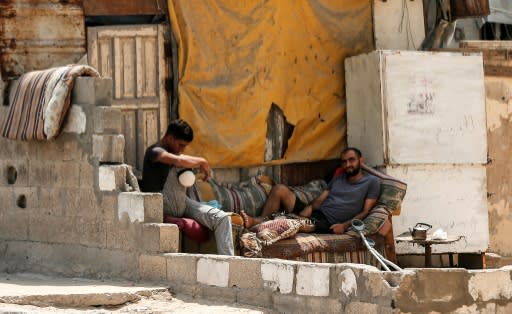 Palestinian refugees chat at the Al-Shati refugee camp, in Gaza City on September 1, 2018