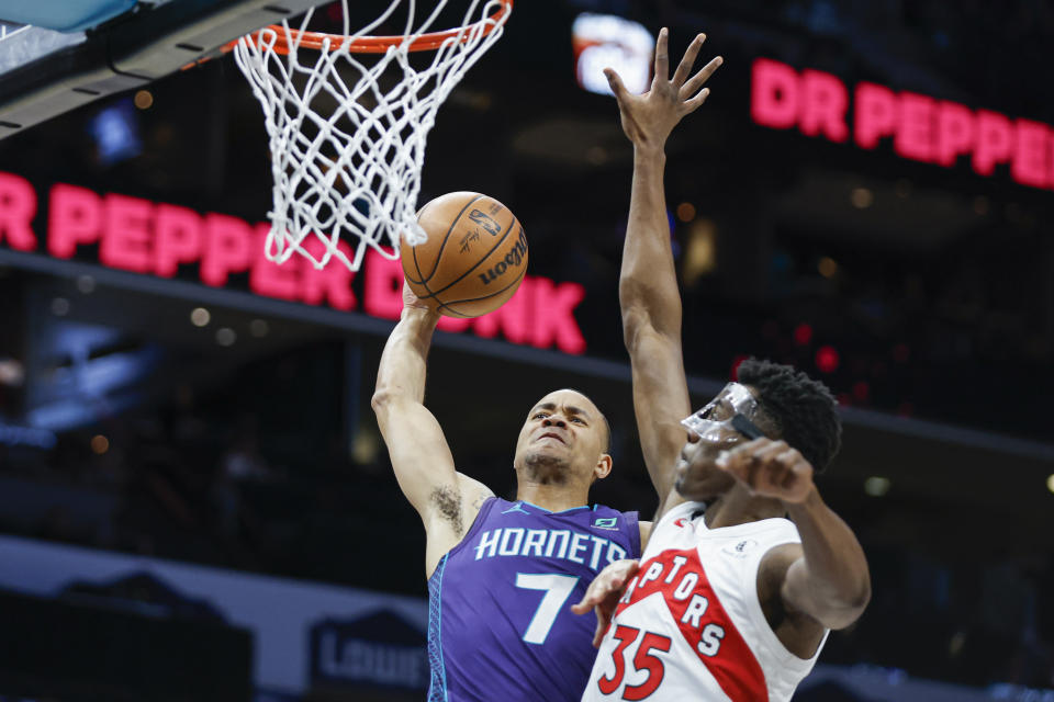 Charlotte Hornets guard Bryce McGowens (7) drives to the basket against Toronto Raptors center Christian Koloko (35) during the first half of an NBA basketball game in Charlotte, N.C., Sunday, April 2, 2023. (AP Photo/Nell Redmond)