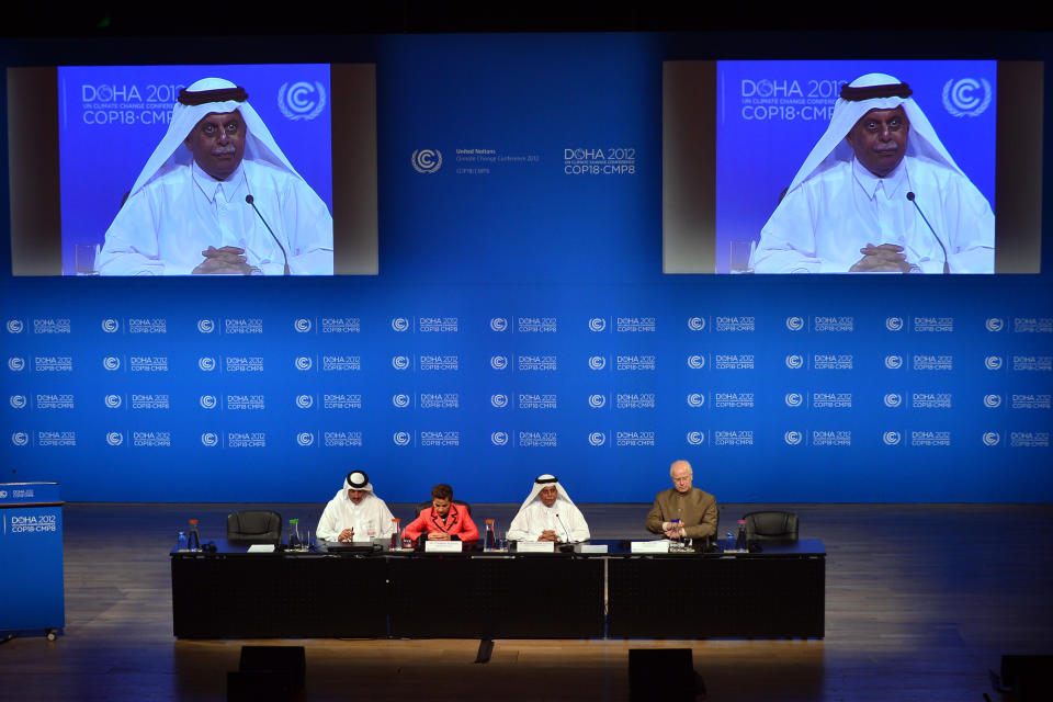 United Nations Convention on Climate Change Executive Secretary Christiana Figueres, second left, speaks during a press conference along side Qatar's Deputy Prime Minister and president of the 18th United Nations Convention on Climate Change, Abdullah bin Hamad Al-Attiyah, second and on screens, right, in Doha, Qatar,Monday, Dec. 3, 2012. (AP Photo/Osama Faisal)