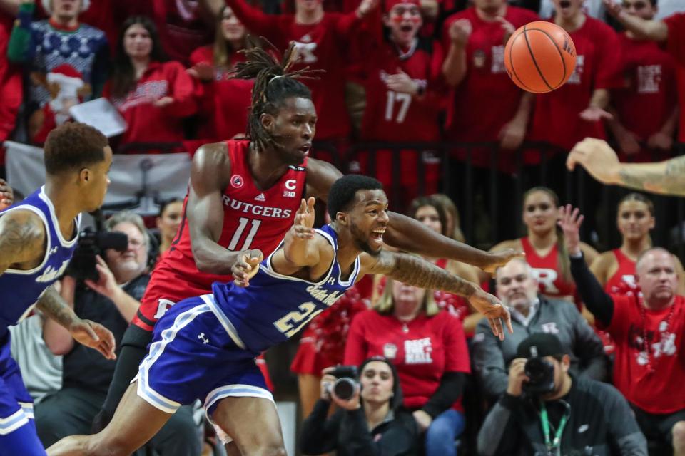 Rutgers Scarlet Knights center Clifford Omoruyi (11) and Seton Hall Pirates forward Tae Davis (22) fight for the ball in the first half at Jersey Mike's Arena.