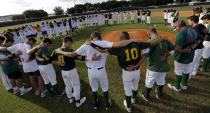 <p>Baseball players from Santa Fe High School and Kingwood Park High School come together around the pitching mound to say a prayer before their game in Deer Park, Texas, Saturday, May 19, 2018. (Photo: David J. Phillip/AP) </p>