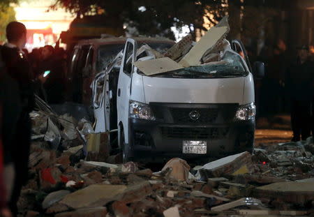 Damaged cars are seen at the scene of a bomb blast in Giza, Egypt, January 21, 2016. REUTERS/Mohamed Abd El Ghany