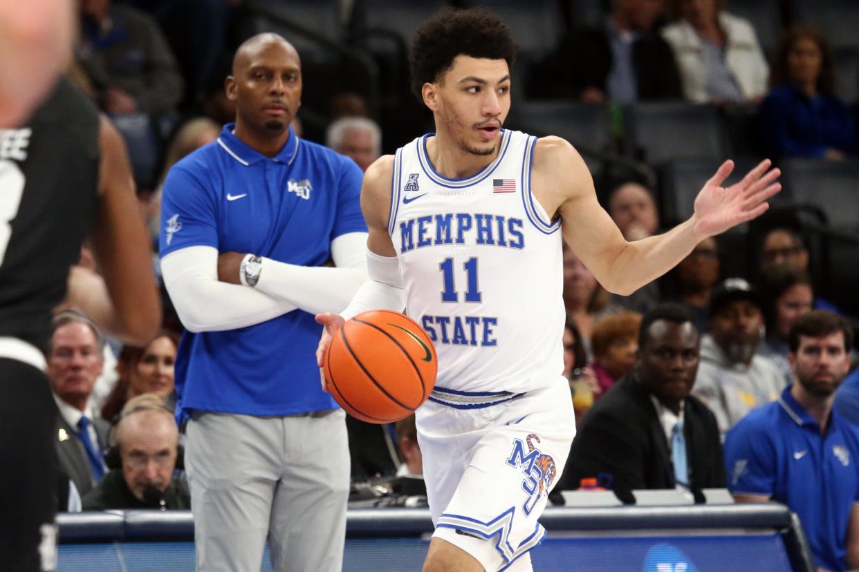 Jan 31, 2024; Memphis, Tennessee, USA; Memphis Tigers guard Jahvon Quinerly (11) dribbles up the court as Memphis Tigers head coach Penny Hardaway (left) watches during the first half against the Rice Owls at FedExForum. Mandatory Credit: Petre Thomas-USA TODAY Sports