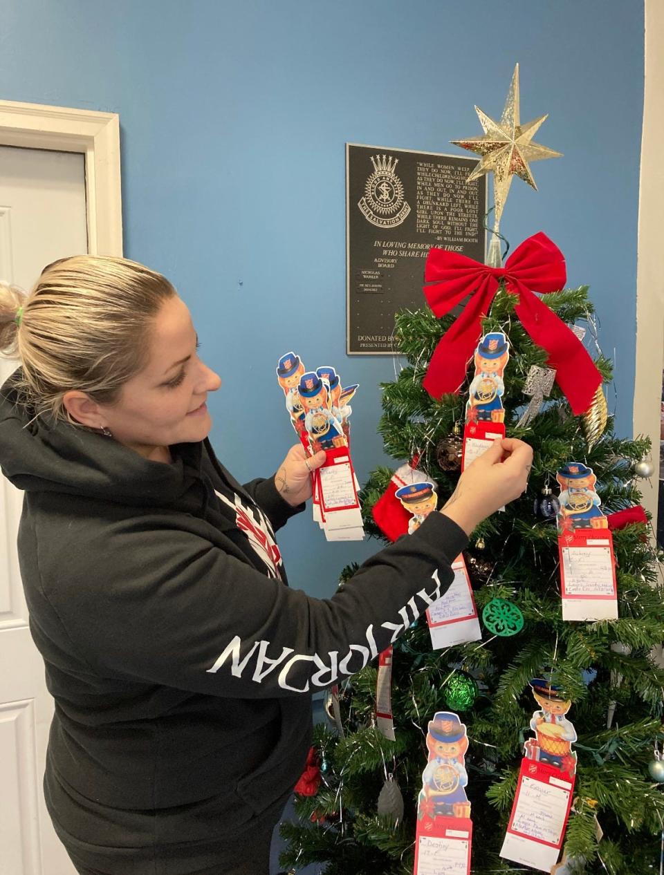 Salvation Army Case Manager Aubrie Bonestell places tags on the angel tree at the Salvation Army Vineland Corps office at 733 E. Chestnut Ave., in Vineland. Donors are invited to select a tag, which has information on an individual child, and buy something for the child to help make the holiday a little brighter. Items must be dropped off by Dec. 13.