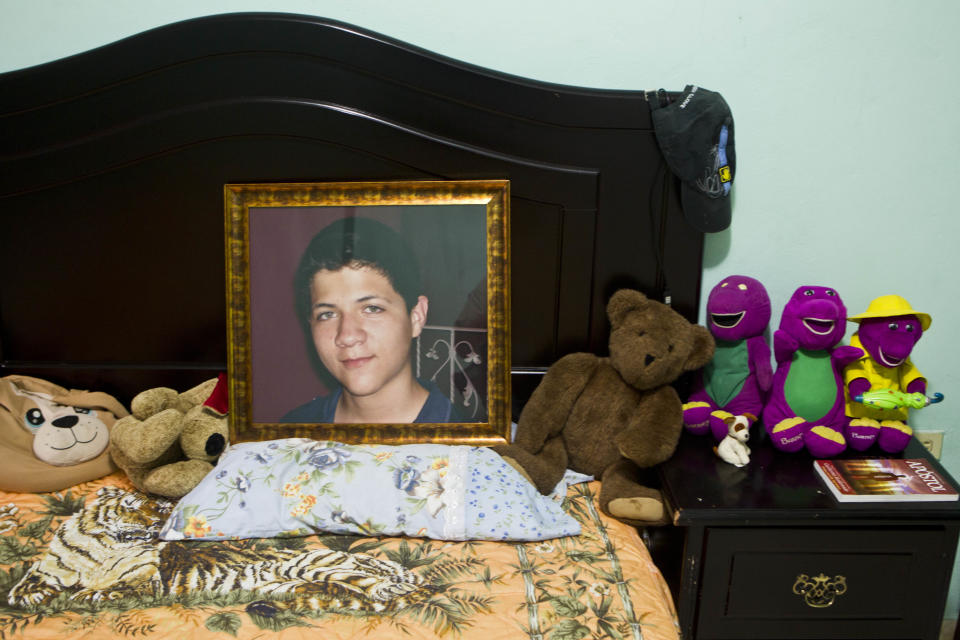 CORRECTS LAST NAME SPELLING AND ADDS FIRST NAME 'EBED' - In this Oct 17, 2012 photo, an image of late Ebed Jaasiel Yanes, 15, sits on his bed at his parent's home in Tegucigalpa, Honduras. According to his relatives, Yanes was killed by soldiers early Sunday, May 27, when he was riding a motorcycle near a military checkpoint. (AP Photo/Esteban Felix)