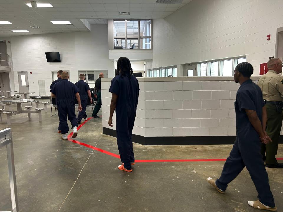 Inmates walk into the newly remodeled section of the Madison Co. Jail for their graduation day in Jackson, Tenn., on June 15, 2023.