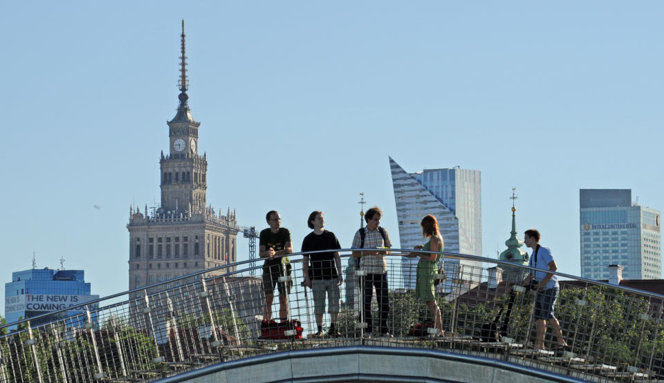 This Aug. 3, 2013 photo shows visitors walking on the roof of the modern Warsaw University Library in Dobra street in Warsaw, Poland. There is a park and a garden on the roof of the modern library offering a nice view over the river. (AP Photo/Alik Keplicz)