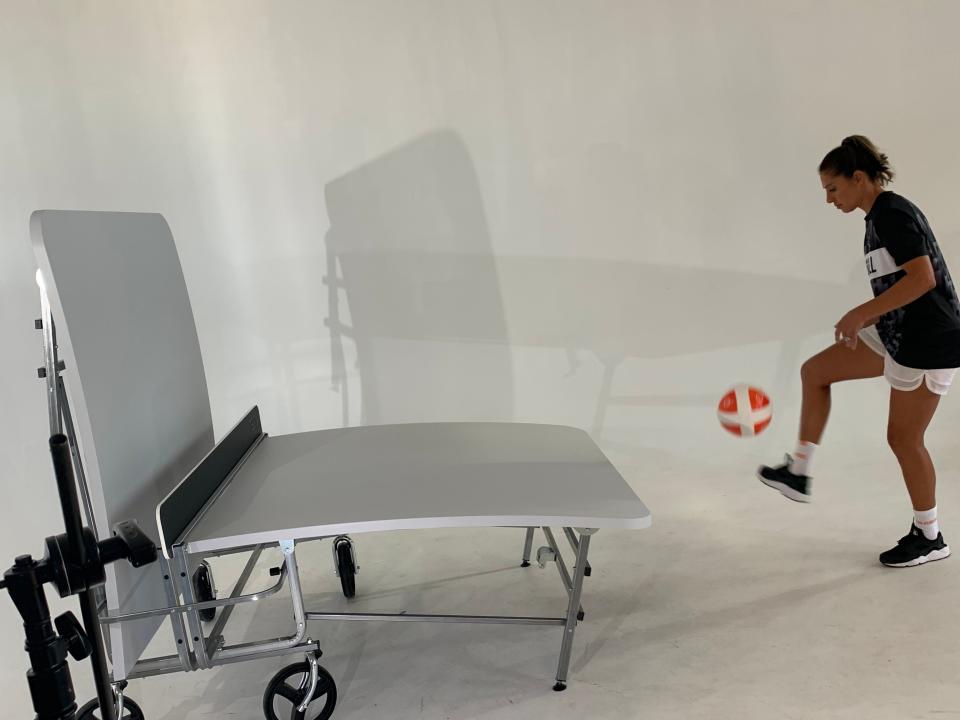 Carli Lloyd takes some touches on a Teqball table.