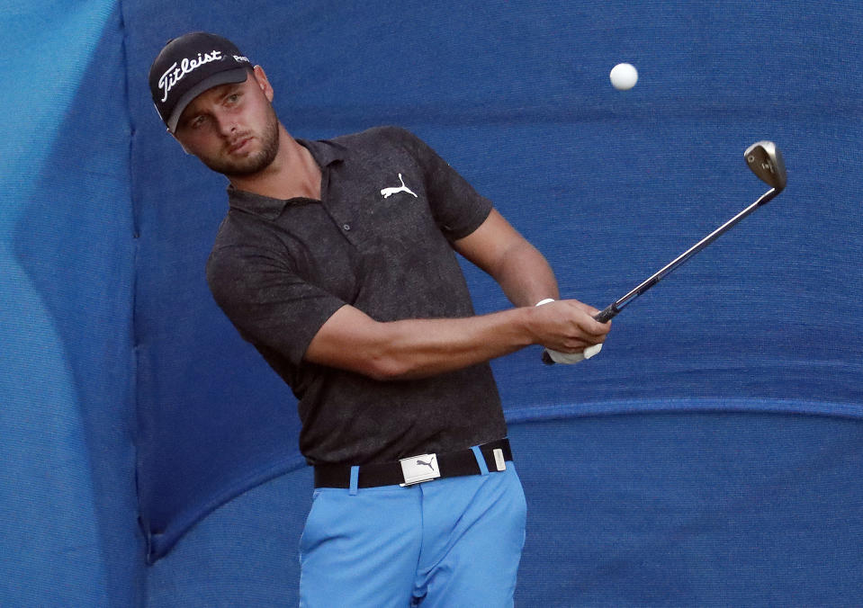 Adam Svensson chips onto the 18th green during the first round of the Sony Ope golf tournament Thursday, Jan. 10, 2019, at Waialae Country Club in Honolulu. (AP Photo/Matt York)