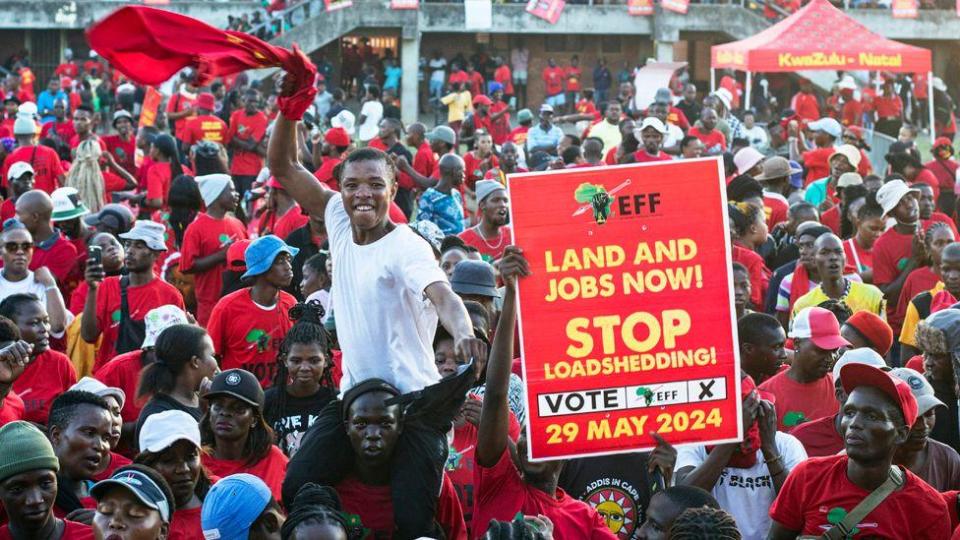 A crowd welcomes Economic Freedom Fighters (EFF) party President Julius Malema as he speaks during an event on May 16, 2024