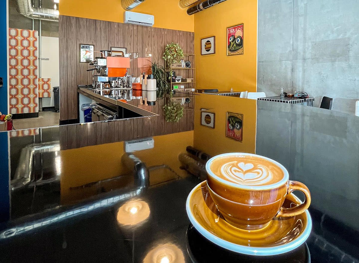 A frothy espresso drink on the counter at Mnemonic Coffee in San Diego