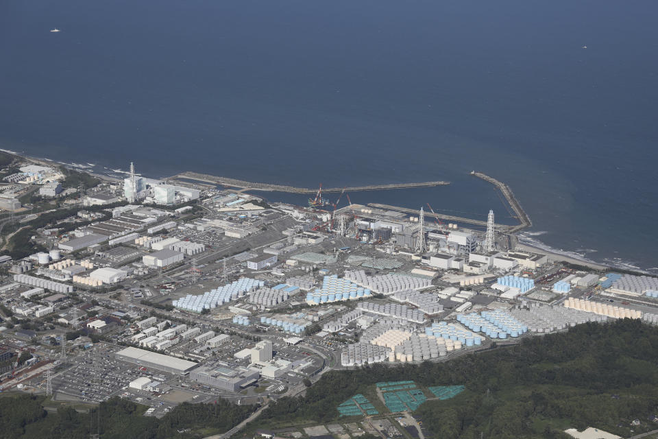 This aerial picture shows storage tanks (bottom) used for storing treated water at TEPCO's crippled Fukushima Daiichi Nuclear Power Plant in Okuma, Fukushima prefecture on August 24, 2023. Japan began releasing wastewater from the crippled Fukushima nuclear plant into the Pacific Ocean on August 24 despite angry opposition from China and local fishermen. (Photo by JIJI PRESS / AFP) / Japan OUT (Photo by STR/JIJI PRESS/AFP via Getty Images)