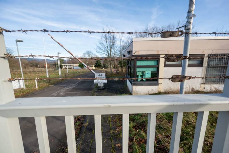 A gate and fences block access to Germany's notorious cyber bunker, where criminals ran an illegal data centre for years. First a Bundeswehr bunker, then a darknet centre - could the bunker on the Moselle become a cheese warehouse or a wine depot? Harald Tittel/dpa