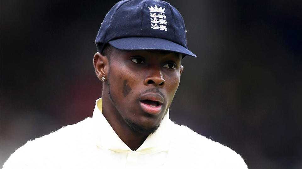 Jofra Archer looking on during a cricket match.