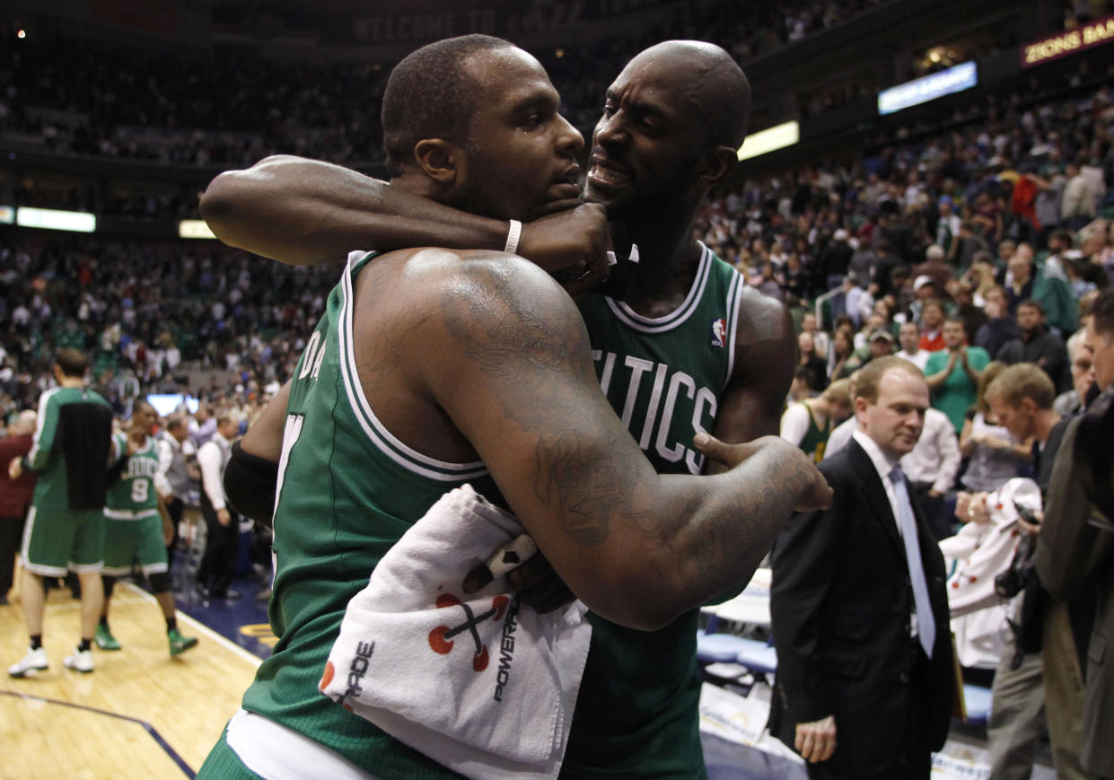 Boston Celtics forwards Glen Davis (L) and Kevin Garnett celebrate their win after the second half of their NBA basketball game against the Utah Jazz in Salt Lake City, Utah, February 28, 2011. REUTERS/Jim Urquhart (UNITED STATES - Tags: SPORT BASKETBALL)