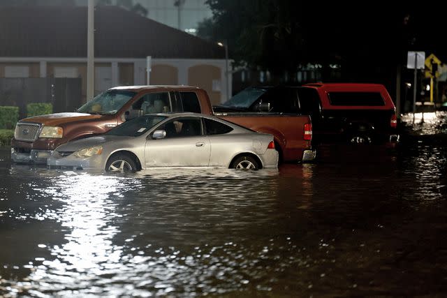 <p>Joe Raedle/Getty</p> Vehicles sit in a flooded street caused by Hurricane Idalia passing offshore on Aug. 30 in St. Petersburg, Florida