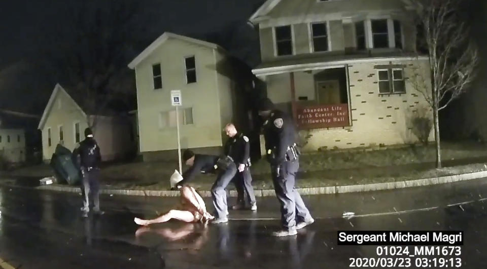 FILE - In this file image taken from police body camera video provided by Roth and Roth LLP, a Rochester police officer puts a hood over the head of Daniel Prude, on March 23, 2020, in Rochester, N.Y. In a decision announced Tuesday, Feb. 23, 2021, a grand jury voted not to charge officers shown on body camera video holding Daniel Prude down naked and handcuffed on a city street last winter until he stopped breathing. His brother Joe Prude said Wednesday, Feb. 24 he had viewed police body camera footage showing what happened after officers caught up with Daniel Prude, naked on a frigid March night, as irrefutable proof of a crime. (Rochester Police via Roth and Roth LLP via AP, File)