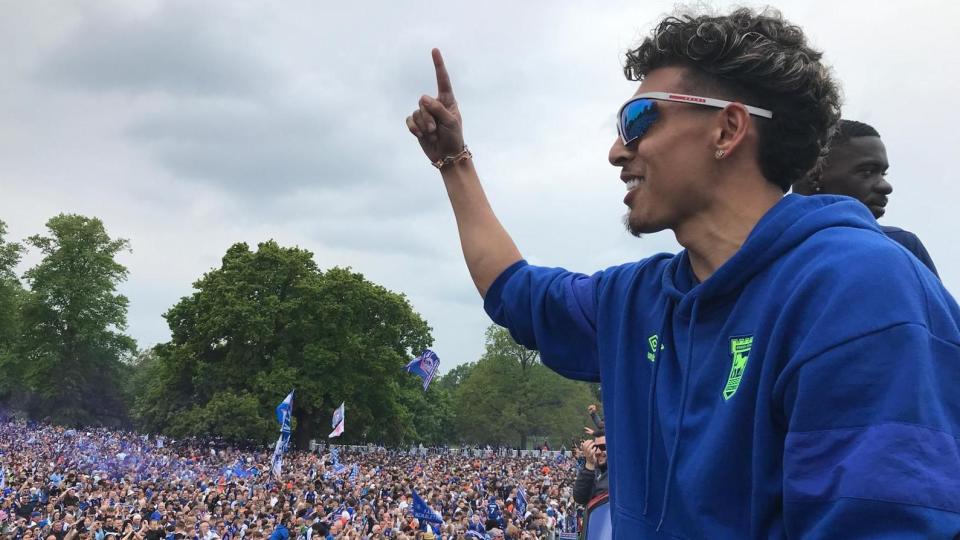 Jeremy Sarmiento holds a finger up to a crowd of Ipswich Town FC fans