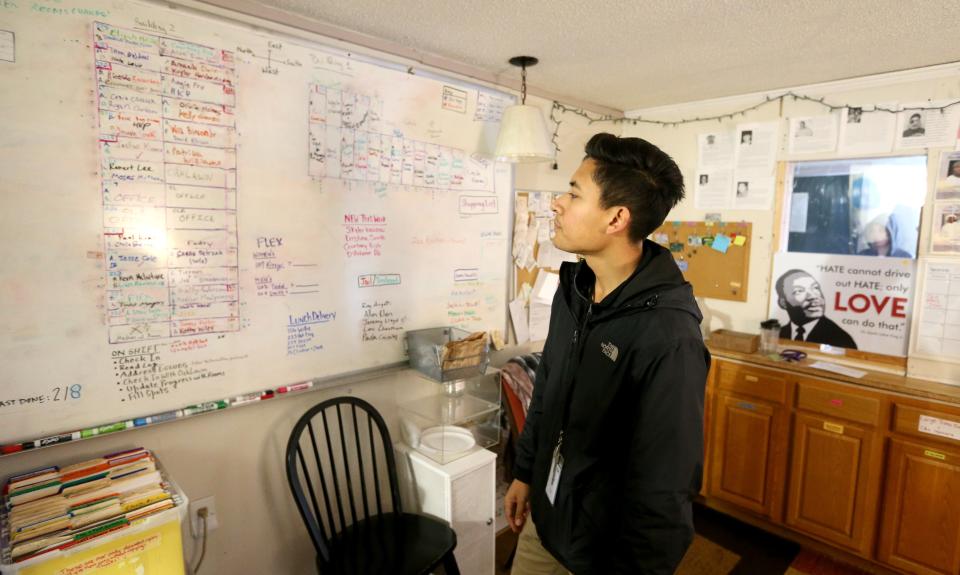 Edgar Medina, coordinator, stands by the white board that holds the schematic of the motel’s buildings and the residents assigned to the rooms Thursday, Feb. 9, 2023, at Motels4Now at the Knights Inn on Lincoln Way West in South Bend.