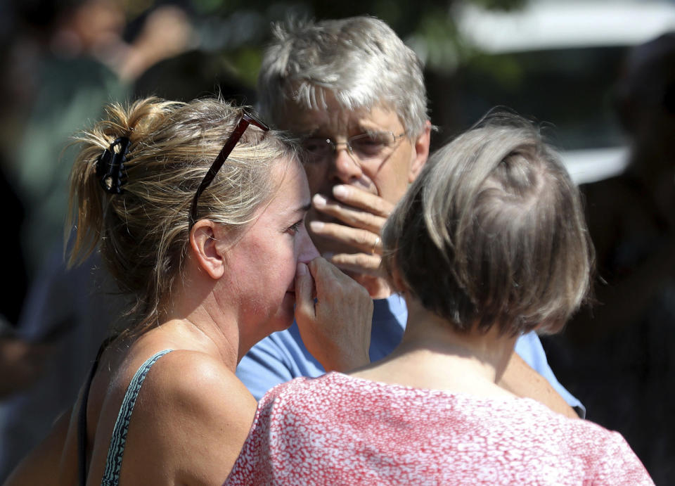 <p>Former Minnehaha Academy employees Elizabeth Van Pilsum, left, and Rick Olson, center, react after an explosion at the school Aug. 2, 2017, in Minneapolis. (David Joles/Star Tribune via AP) </p>