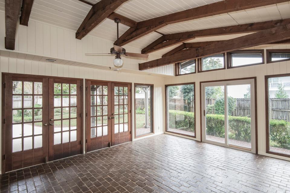 A spacious sunroom is perfect for hosting friends and family.
