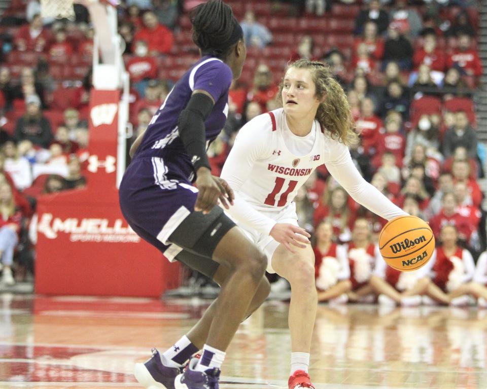Wisconsin's Maty Wilke looks for a teammate while Northwestern's Hailey Weaver defends on Sunday Jan. 29, 2023 at the Kohl Center in Madison, Wis.