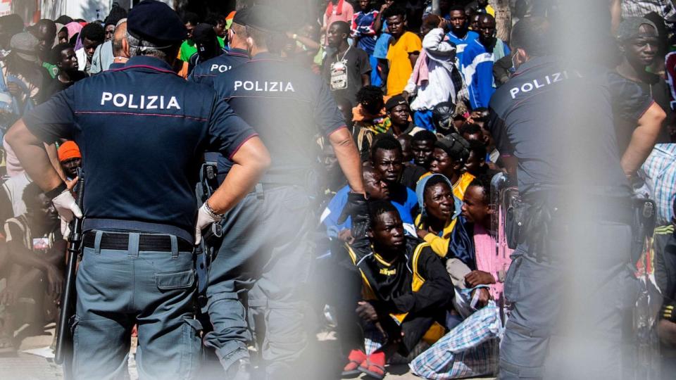 PHOTO: Migrants gather outside the operational center on the Italian island of Lampedusa on Sept. 14, 2023. (Alessandro Serrano/AFP via Getty Images)