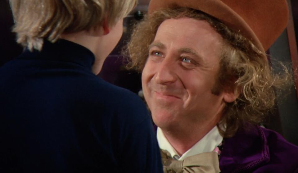 Gene Wilder as Willy Wonka smiles at Charlie in the glass elevator