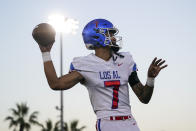 Los Alamitos High School quarterback Malachi Nelson warms up before a high school football game against Newport Harbor High School on Friday, Sept. 30, 2022, in Newport Beach, Calif. (AP Photo/Ashley Landis)