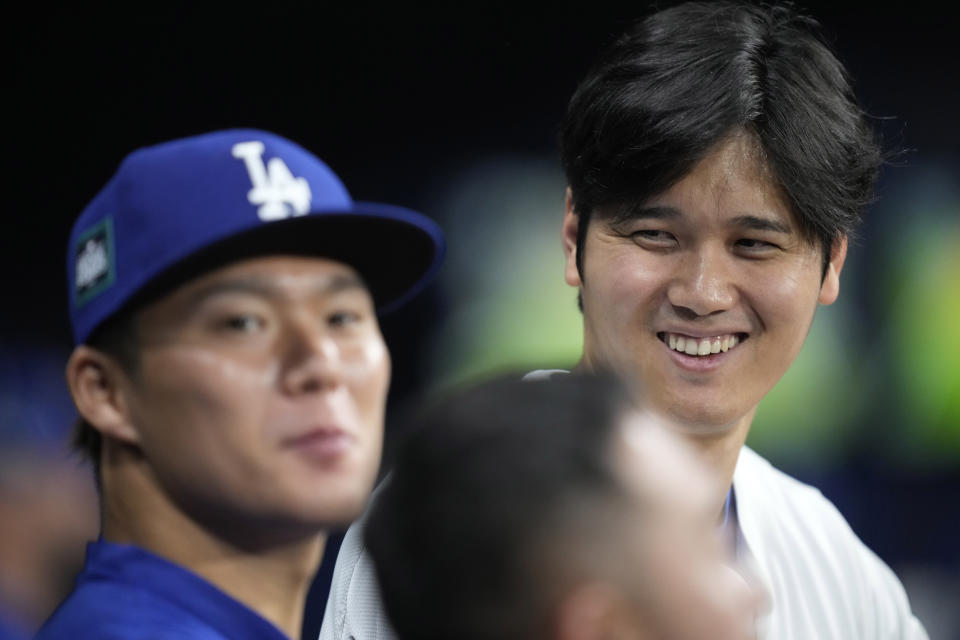 Los Angeles Dodgers designated hitter Shohei Ohtani, right, talks with starting pitcher Yoshinobu Yamamoto during the fourth inning of a baseball game against the San Diego Padres at the Gocheok Sky Dome in Seoul, South Korea Thursday, March 21, 2024, in Seoul, South Korea. (AP Photo/Lee Jin-man)