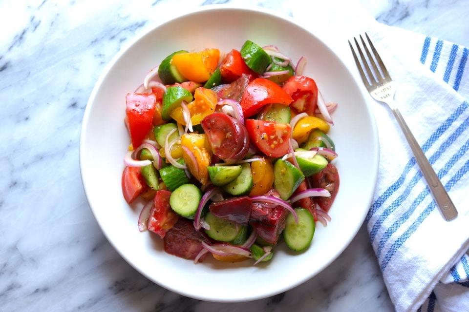 <p>The Hungry Hutch</p><p>Heirloom tomatoes and Persian cucumbers get tossed with thinly sliced red onion and a handful of other ingredients for a simple, delicious summer salad.</p><p><strong>Get the Recipe</strong><strong>: <a href="https://www.thehungryhutch.com/cucumber-heirloom-tomato-salad-recipe-balsamic/" rel="nofollow noopener" target="_blank" data-ylk="slk:Cucumber Tomato Salad;elm:context_link;itc:0;sec:content-canvas" class="link ">Cucumber Tomato Salad</a></strong></p>