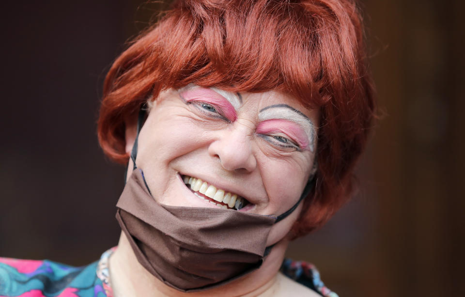 Actor Tim Hudson dressed as a pantomime dame poses for photographers as they march on Parliament to demand more support for the theatre sector amid the COVID-19 pandemic in London, Wednesday, Sept. 30, 2020. (AP Photo/Frank Augstein)