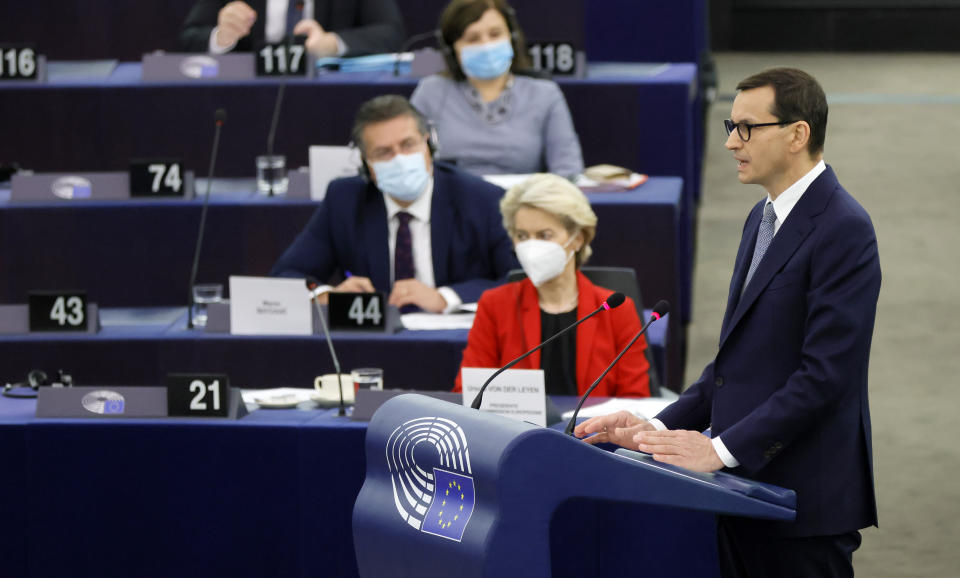 Poland's Prime Minister Mateusz Morawiecki, right, delivers his speech Tuesday, Oct. 19, 2021 at the European Parliament while European Commission president Ursula von der Leyen , in red, listens, in Strasbourg, eastern France. The European Union's top official locked horns Tuesday with Poland's prime minister, arguing that a recent ruling from the country's constitutional court challenging the supremacy of EU laws is a threat to the bloc's foundations and won't be left unanswered. (Ronald Wittek, Pool Photo via AP)