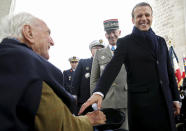 French President Emmanuel Macron greets veteran Jacques Lewis during ceremonies marking the 74th anniversary of World War II victory in Europe, under the Arc de Triomphe Wednesday May 8, 2019 in Paris . (Christian Hartmann, Pool via AP)