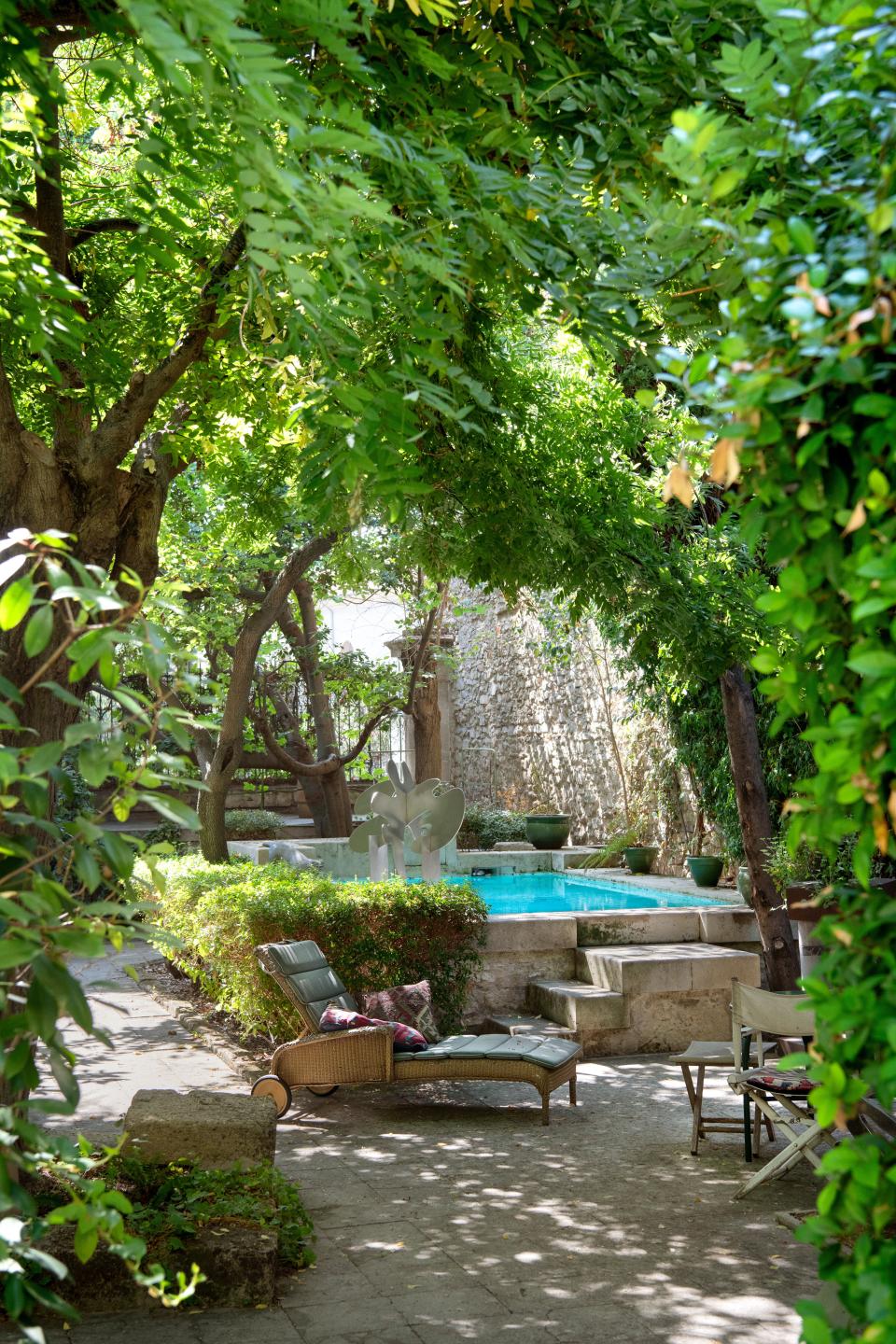 The courtyard features a pool with a sculpture by de Rougemont.