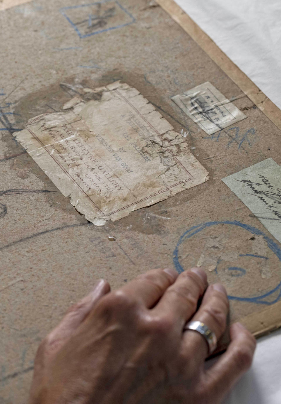 he National Galleries of Scotland (NGS) discovered the back of the canvas was covered in layers of glue and cardboard. Underneath is the self-portrait – the condition is unknonwn. / Credit: Neil Hanna