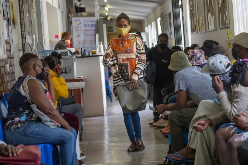 Volunteers wait to be checked at a vaccine trial facility in Soweto, South Africa.