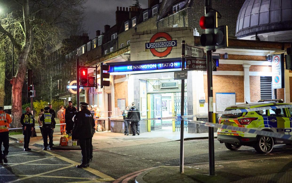 Police attend the scene of a stabbing at Kennington underground station in south London
