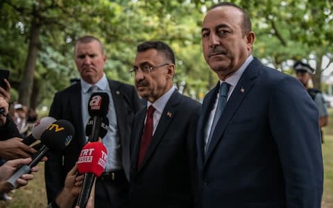 urkey's Vice-President Fuat Oktay (R) and Foreign Minister Mevlut Cavusoglu (C) speak to the media after visiting Al Noor mosque in Christchurch - Credit: Getty